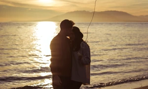 couple with heart balloon hugging sea shore evening jpg