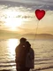 couple with heart balloon hugging sea shore evening jpg