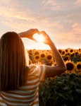 back view woman making heart shaped hands sunset jpg