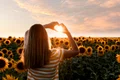 back view woman making heart shaped hands sunset jpg