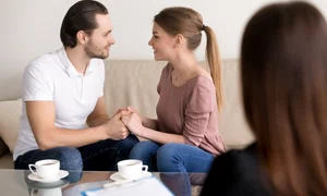 happy smiling young couple holding hands consulting psychologist planning wedding jpg