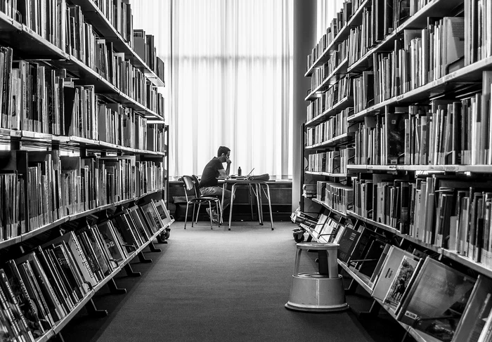 foto biblioteca carti tanar citind