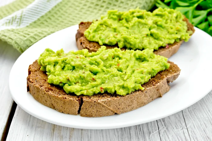 35973827 sandwich with guacamole on light board jpeg
