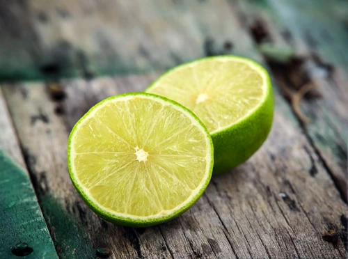 Fresh limes on wooden background jpeg