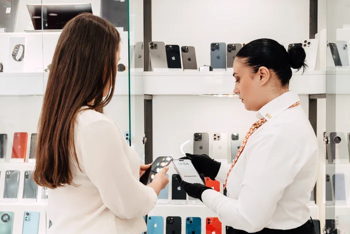 O femeie cumpără un telefon second hand