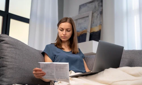 woman reading instructions covid test home jpg