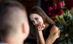 man young cheerful woman with hand chin near flowers jpg
