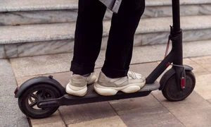 man riding his electric scooter outdoors jpg