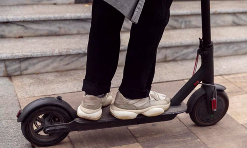 man riding his electric scooter outdoors jpg