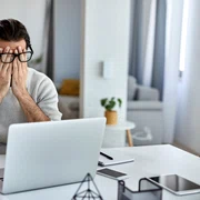 businessman feeling exhausted after working laptop home jpg