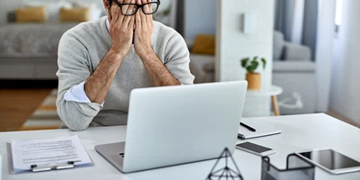 businessman feeling exhausted after working laptop home jpg