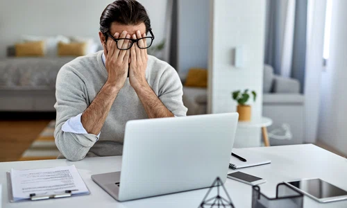 businessman feeling exhausted after working laptop home jpg