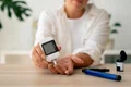 diabetic person checking their glucose level jpg