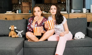 young women watching television jpg