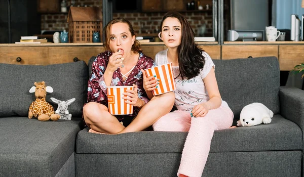 young women watching television jpg