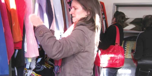 Tânăra încearcă să vadă dacă puloverul are vreun defect