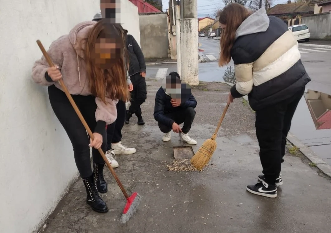 Tineri puşi să măture cojile de seminţe Foto: Primăria Constanţa
