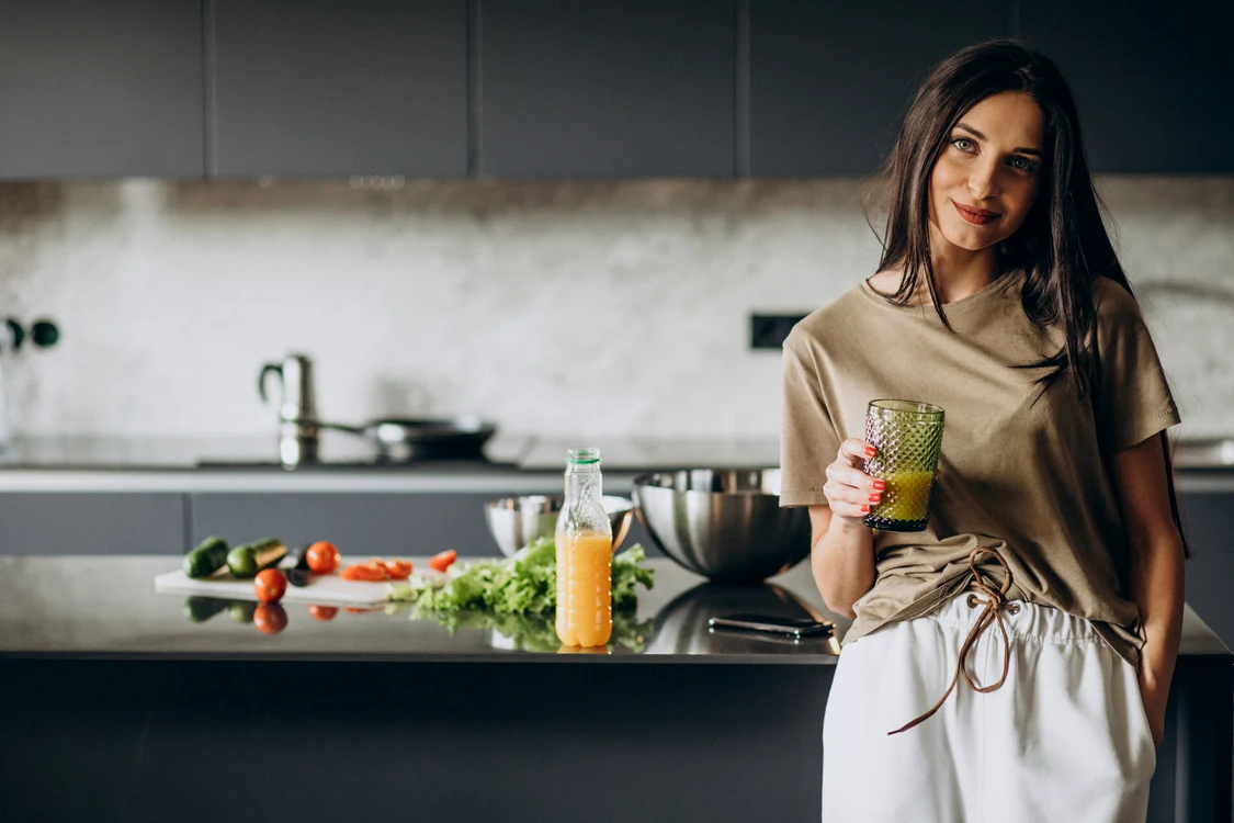 young woman drinking juice home jpg