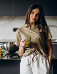 young woman drinking juice home jpg