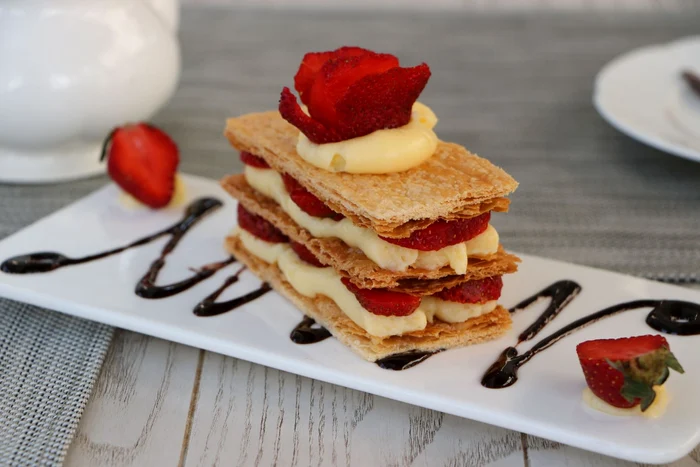 51347563 strawberries mille feuille cake in white plate jpeg