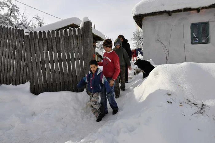 Copiii din comunităţi sărace înoată prin zăpadă