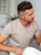 side view attentive man sitting couch calm down his serious girlfriend with crossed arms home jpg