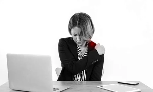 woman with aching shoulder in office 23 2147768295 jpeg