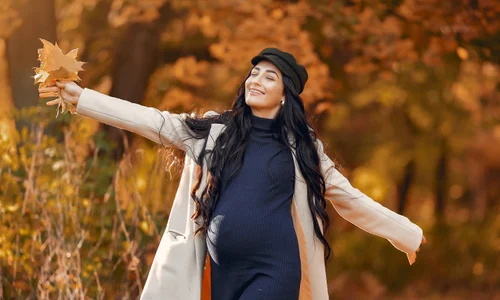 pregnant woman brown coat autumn park jpg