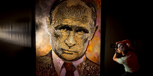 Un fotograf surprinde tabloul cu portretul preşedintelui rus Vladimir Putin creat din cartuse de imprimanta al artistei ucrainiene Dasha Marchenko la o galerie de artă din Kiev Ucraina FOTO AP