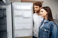 young couple selecting new refrigerator household appliance store jpg