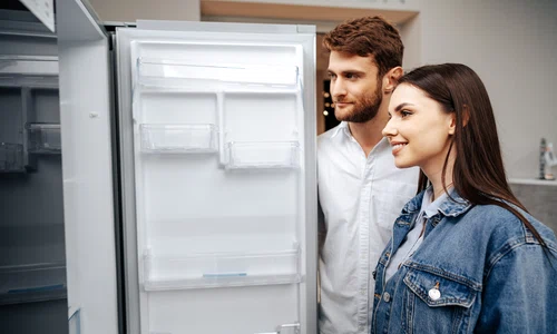young couple selecting new refrigerator household appliance store jpg