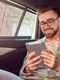smiling successful stylish young businessman gray suit pink shirt using tablet riding back seat luxury car jpg