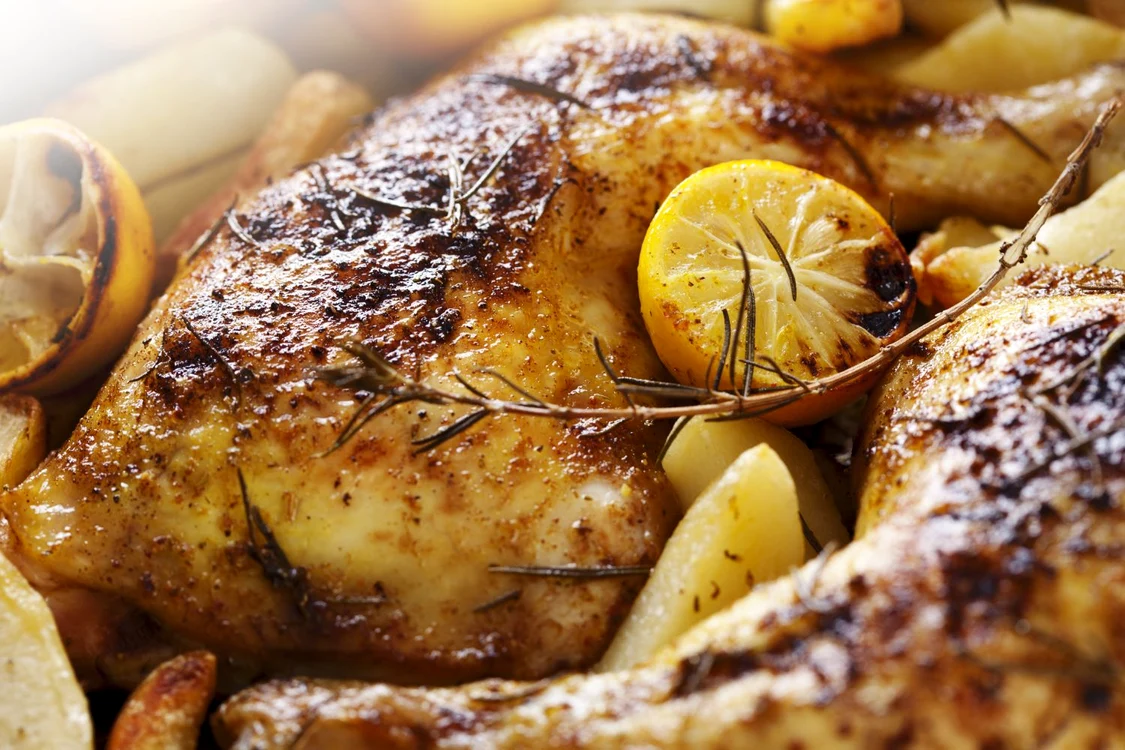 12615454   closeup of roast chicken and oven potatoes jpeg