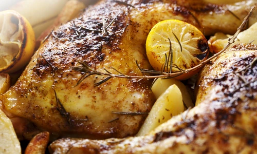 12615454   closeup of roast chicken and oven potatoes jpeg