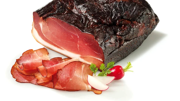 Felii de jambon lângă o bucată mai mare