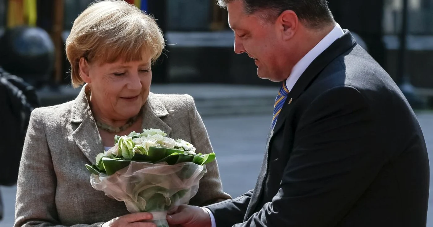 Cancelarul german, Angela Merkel, întâmpinată cu flori de preşedntele ucrainean Petro Poroşenko