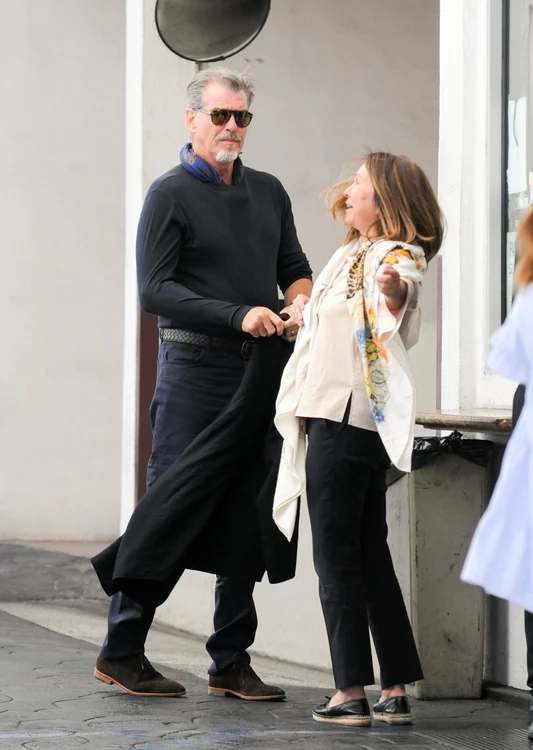 Pierce Brosnan greets fans while parking jpeg