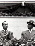 Alexandru Moghioroș, Petru Groza și Gheorghe Gheorghiu-Dej, în tribuna centrală din Piața Aviatorilor la marea demonstrație a oamenilor muncii, în cinstea zilei de 1 Mai 1953 (©  „Fototeca online a comunismului românesc”, cota: 25 (25)/1953)