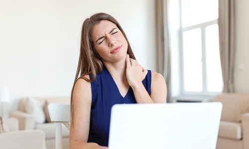 young businesswoman suffering from neckache massaging her neck while sitting her working place home office copy 2 jpg