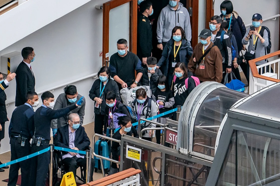 Pasagerii părăsesc nava de croazieră World Dream la terminalul Kai Tak din Hong Kong. Cei 1.800 de membri ai echipajului au fost testaţi negativ pentru coronavirus. Nava era andocată şi pasagerii blocaţi de mai bine de patru zile. FOTO Anthony Kwan / Getty Images