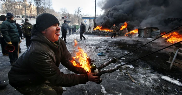 Un protestatar se pregăteşte să arunce un cocktail Molotov. FOTO Sergei Grits
