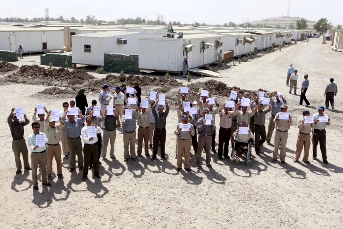 Exilaţi iranieni demonstrează la Camp Liberty din Bagdad, în timpul unei vizite oficiale. Cel puţin 16 obuze au lovit fosta bază militară FOTO AP