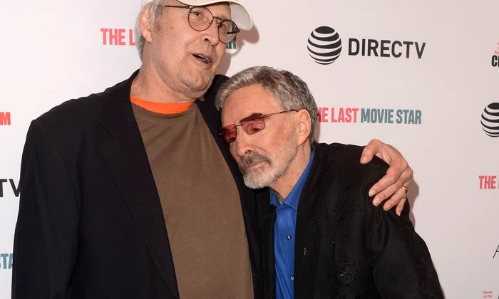 Burt Reynolds and Chevy Chase kiss on the red caroet at the premiere of "The Last Movie Star" jpeg