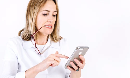 woman with glasses browsing smartphone jpg