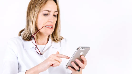 woman with glasses browsing smartphone jpg