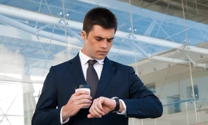 serious business man checking time watch outdoors jpg