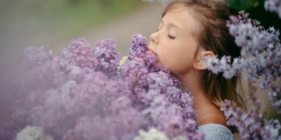 girl smelling lilac flowers in a garden setting 2026 03 24 07 37 18 utc jpg