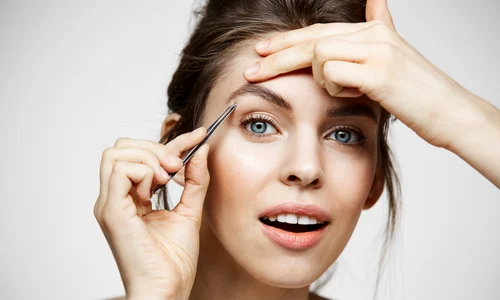 young beautiful woman with perfect clean skin tweeze eyebrows facial treatment (1) jpg