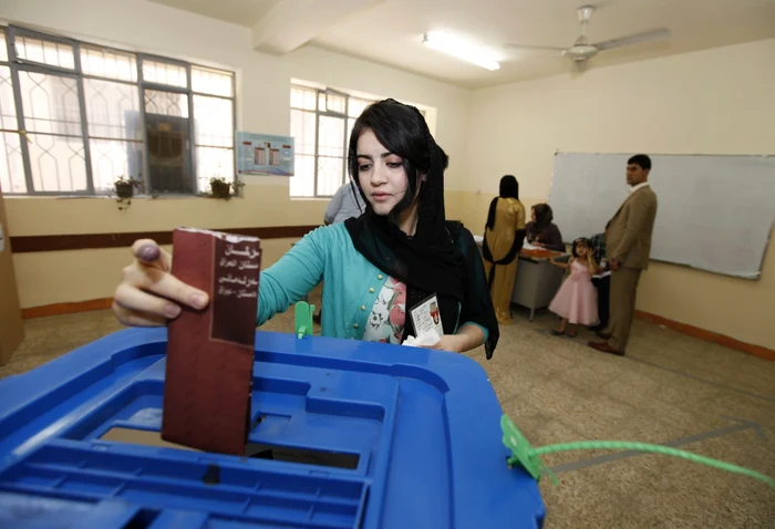 O femeie din Kurdistan îşi depune votul în urna sigilată. FOTO: Reuters