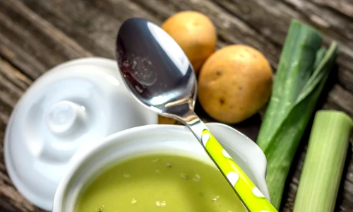 Homemade creamy leek soup on wooden background jpeg